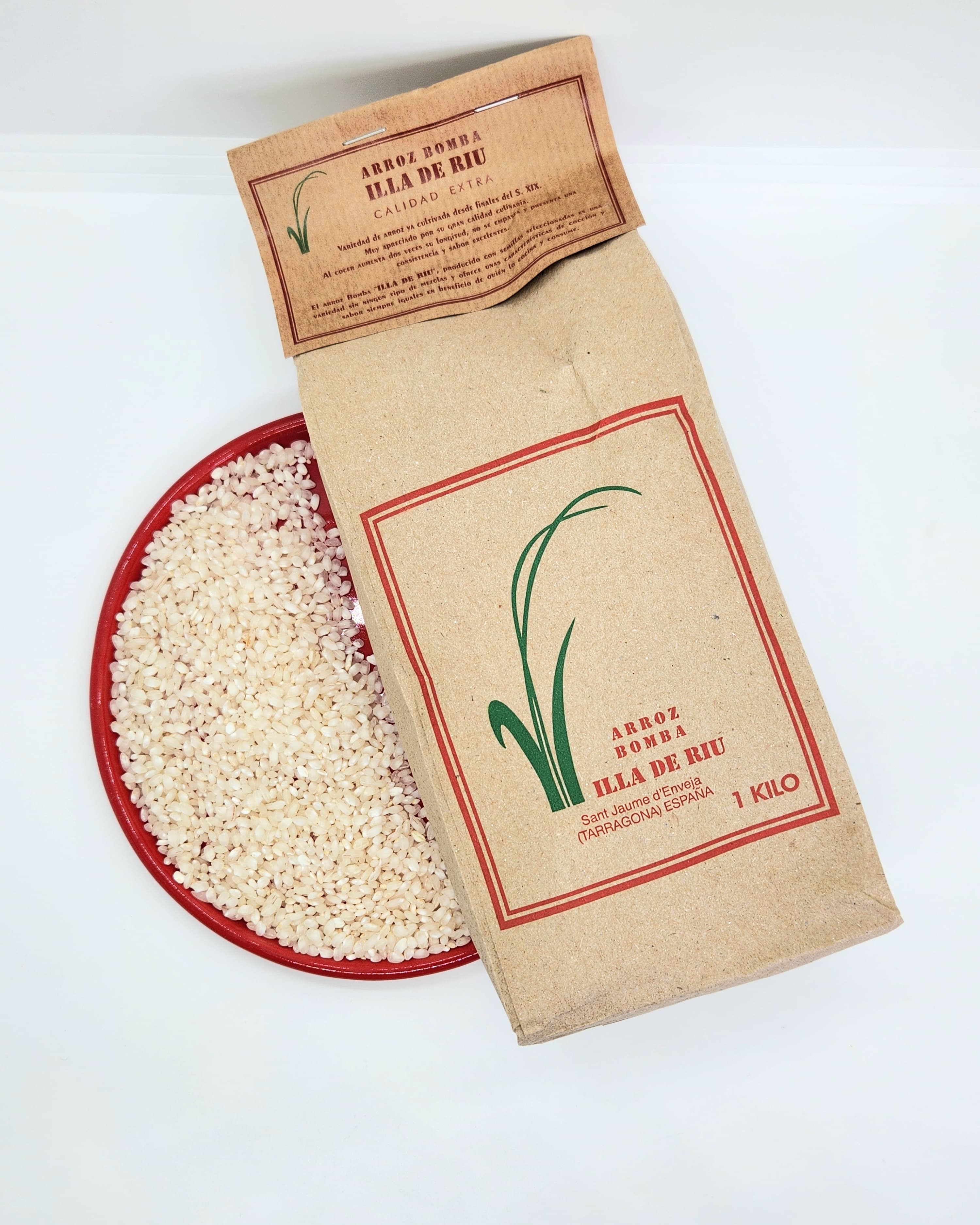Brown paper bag of Arroz Bomba rice next to a red plate of white rice.
